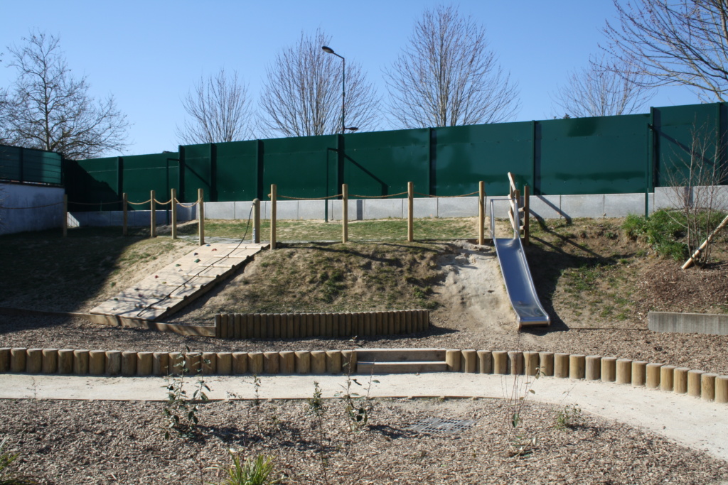Aménagement du talus avec une structure d'escalade et un toboggan