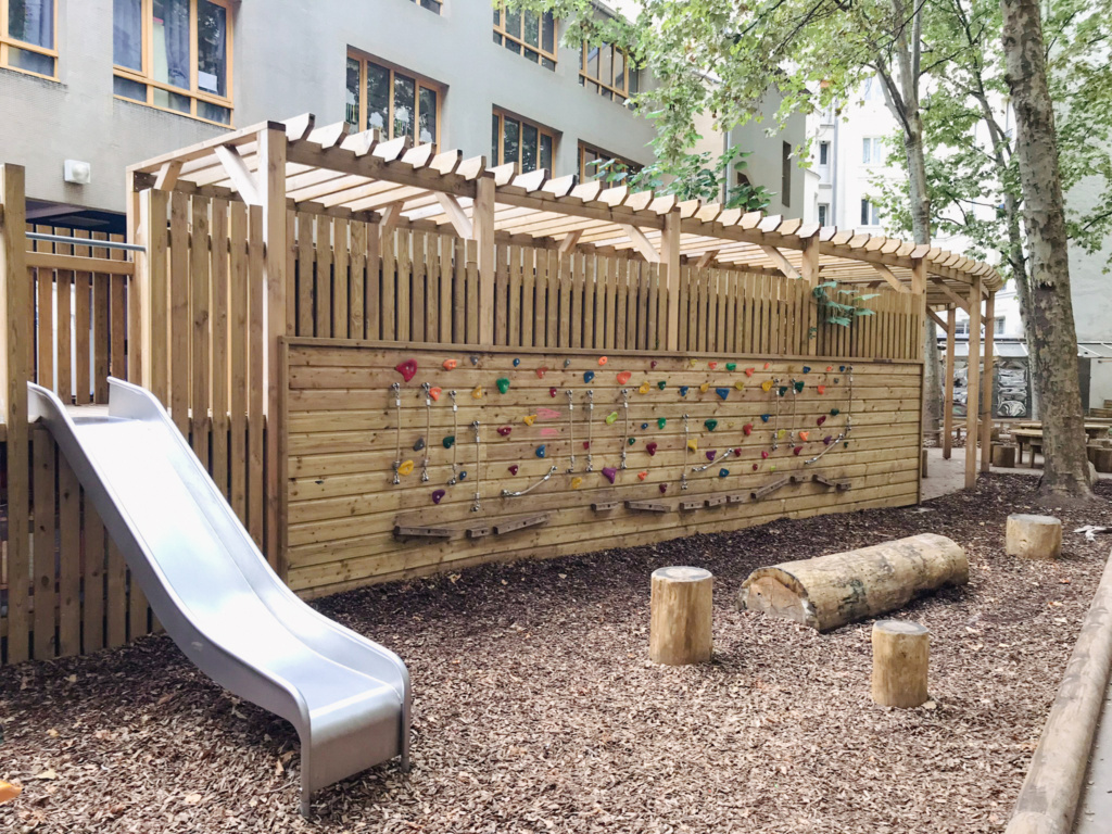 La limite est à la fois jeux, protection solaire et support de plantations, côté élémentaire...